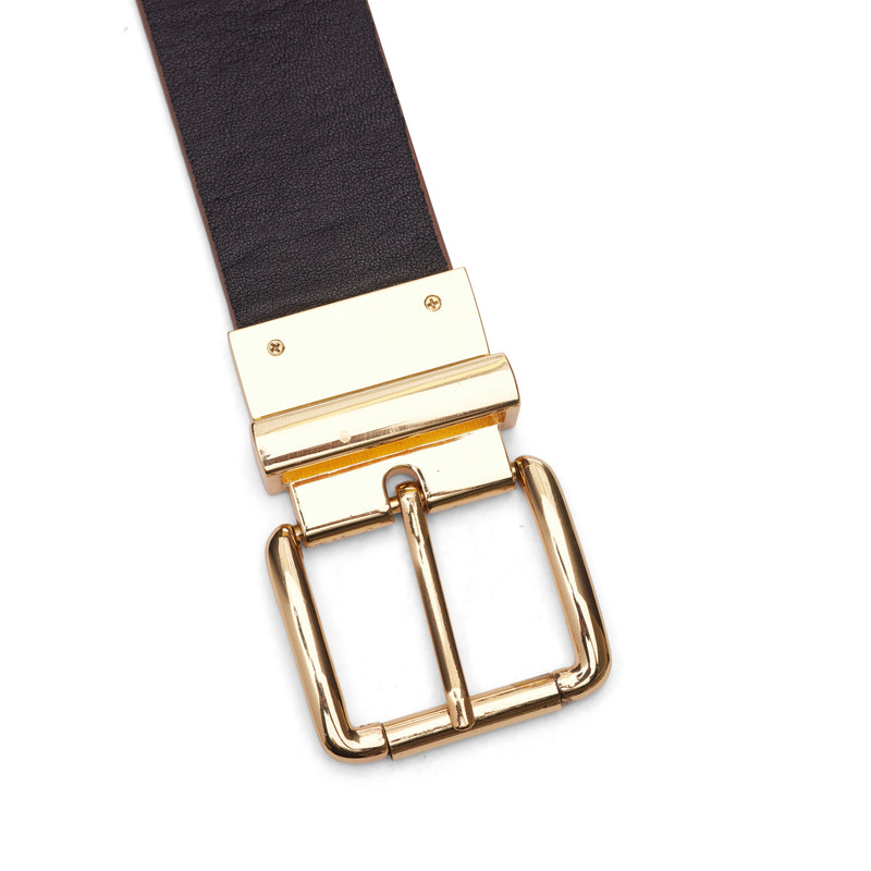 The Bronte belt is a reversible, black and cognac colored belt that has seven holes and a gold belt buckle.